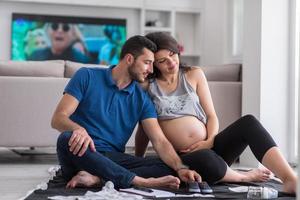 pregnant couple checking a list of things for their unborn baby photo