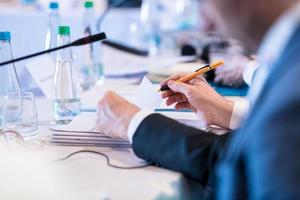 close up of business people taking notes photo