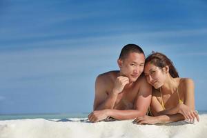 happy young  couple enjoying summer on beach photo