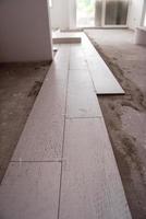 Ceramic wood effect tiles and tools for tiler on the floor photo