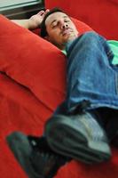 man relaxing on sofa photo