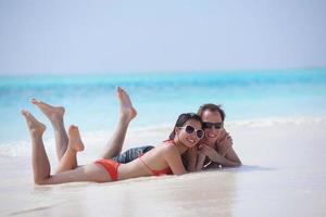 happy young couple have fun on beach photo