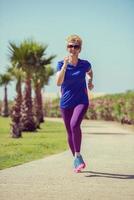 young female runner training for marathon photo