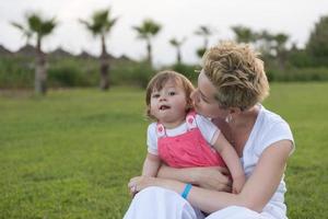 mother and little daughter playing at backyard photo