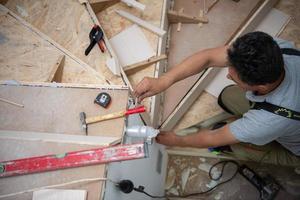 carpenter installing wooden stairs photo