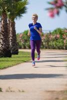 young female runner training for marathon photo