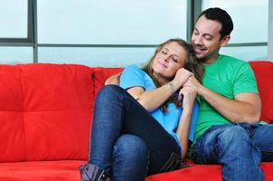 happy couple relax on red sofa photo