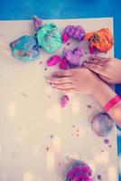 kid hands Playing with Colorful Clay photo