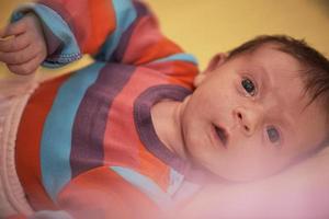 One month newborn baby sleeping  in bed photo