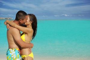 happy young  couple enjoying summer on beach photo