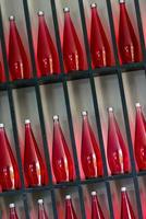 bottles of red juice in modern restaurant photo