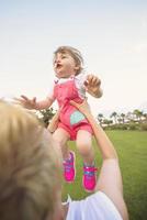 mother and little daughter playing at backyard photo