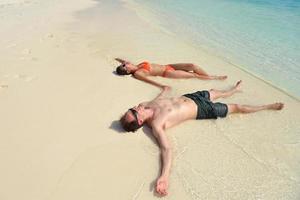 happy young couple have fun on beach photo