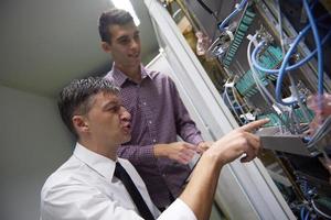 network engineers in server room photo
