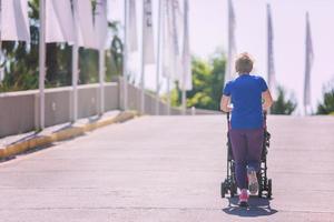 mom with baby stroller jogging photo