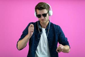 guy wears glasses and headphones while dancing and having fun photo