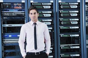 young it engineer in datacenter server room photo