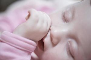 newborn baby sleeping  at home in bed photo