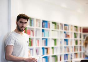 student in school library using tablet for research photo