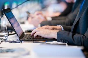 close up of business people hands using laptop computer photo