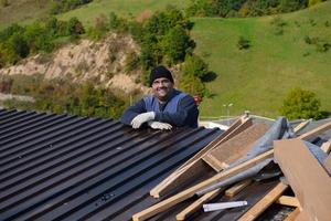 Construction worker installing a new roof photo