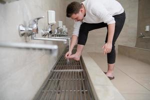 A Muslim takes ablution for prayer. Islamic religious rite photo