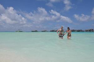 happy young couple have fun on beach photo