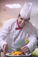 chef serving vegetable salad photo