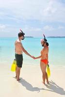 happy young couple have fun on beach photo