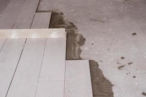 Ceramic wood effect tiles and tools for tiler on the floor photo