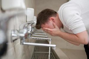 A Muslim takes ablution for prayer. Islamic religious rite photo