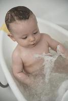 cute little baby girl taking a bath photo