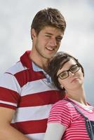 Portrait of romantic young couple smiling together outdoor photo