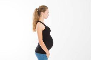 Profile portrait of blonde caucasian woman with pregnant belly isolated on white background . Pregnancy concept. Copy space