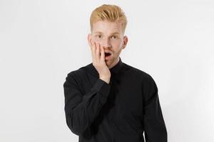 emocionado sorprendido shock joven aislado sobre fondo gris. chico pelirrojo feliz con barba roja en camisa negra elegante. éxito y aprobar el concepto de examen. copie el espacio. primer plano de la expresión de la cara. foto