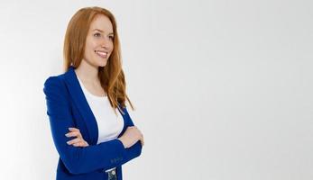 Happy red haired business woman in template blank white t shirt and stylish jacket isolated on gray background. Self career and job consulting knowledge. Young ceo entrepreneur and casual clothes photo