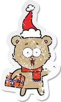 laughing teddy  bear with christmas present wearing santa hat vector