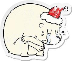 crying distressed sticker cartoon of a polar bear wearing santa hat vector