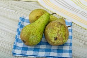 Ripe pears on wooden background photo