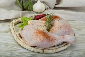 Chicken thigh on wooden board and wooden background photo