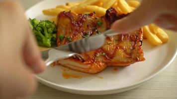 slicing grilled chicken steak with potato chips or french fries video