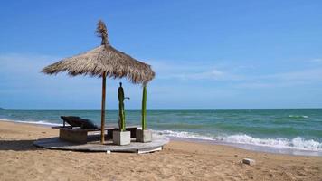 beach chair on beach with sea and blue sky background video