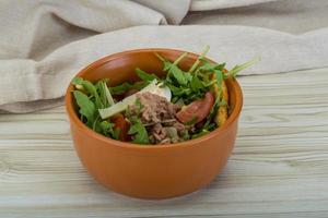 Tuna salad in a bowl on wooden background photo