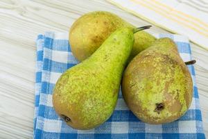 Ripe pears on wooden background photo