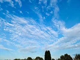 Beautiful fluffy white cloud formations in a deep blue summer sky photo