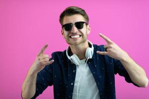 guy wears glasses and headphones while dancing and having fun photo