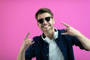 guy wears glasses and headphones while dancing and having fun photo