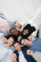 top view of a diverse group of people lying on the floor and symbolizing togetherness photo