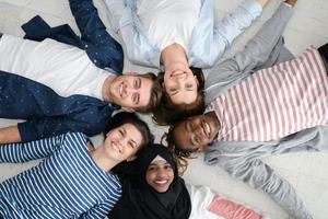 top view of a diverse group of people lying on the floor and symbolizing togetherness photo