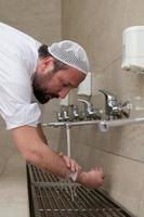 A Muslim takes ablution for prayer. Islamic religious rite photo